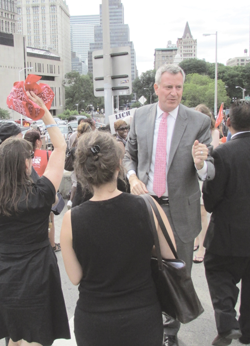 Bill de Blasio walks with LICH supporters over the Brooklyn Bridge last summer.