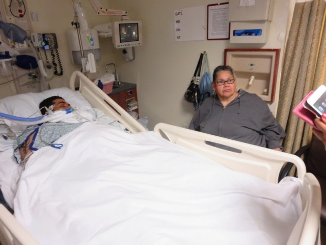 Danny Cruz lying in a coma at Methodist Hospital with his mother Mercedes.